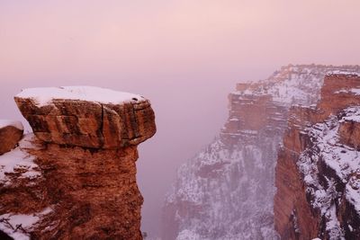 Rock formation against sky during winter