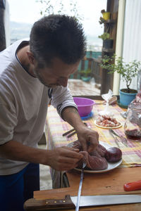 Man preparing meat on a spit for a barbecue