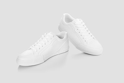 Close-up of shoes against white background