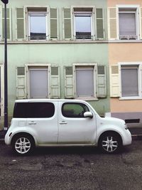 Vintage car on street against building