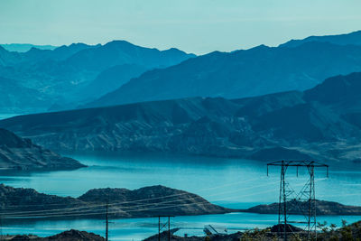 Blue river and rocky mountains against sky