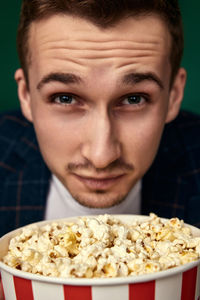 Close-up portrait of man holding food