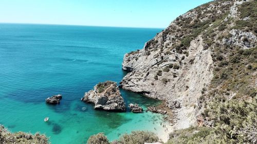 High angle view of sea and rock formations against sky