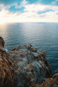 Rock formation in sea against sky