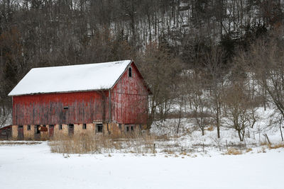 Weathered red barn in winter