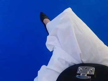 Low angle view of man against blue sky