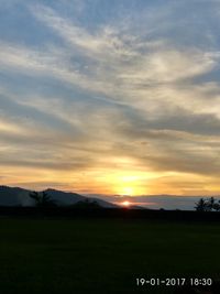 Scenic view of field against sky during sunset