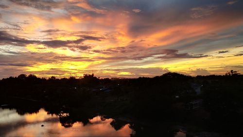 Scenic view of orange sky over lake during sunset