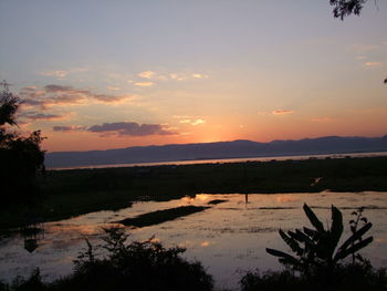 Scenic view of lake against sky during sunset