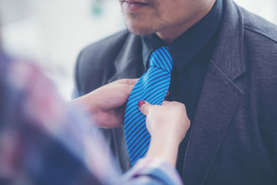 Midsection of a man holding flower