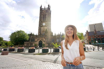 Beautiful young woman in the city of manchester on sunny day, england