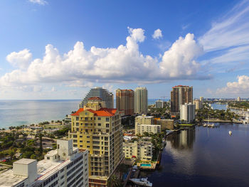 View of cityscape against cloudy sky
