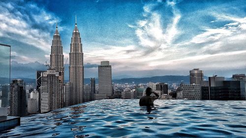 City skyline against cloudy sky