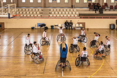 High angle view of people sitting on wooden floor