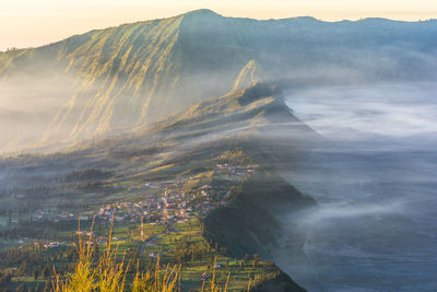 Scenic view of mountains and sea during foggy weather