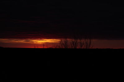 Silhouette of bare tree against sky at sunset