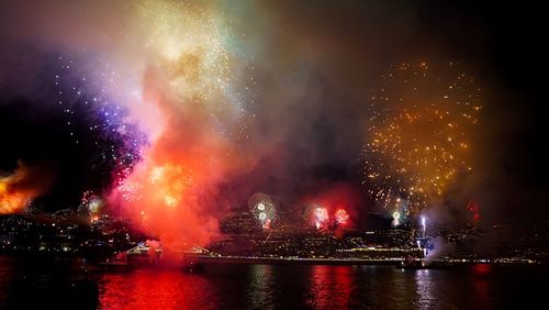 Firework display over city at night