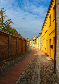 Empty alley amidst buildings in city