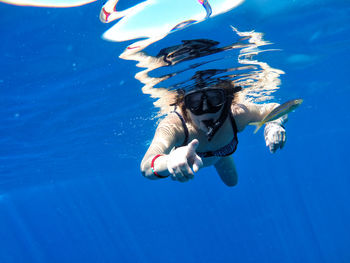 Young woman swimming in sea