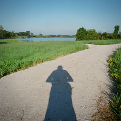 Shadow of people on grassy field