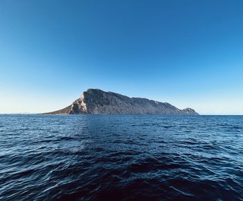 Scenic view of sea against clear blue sky- tavolara island