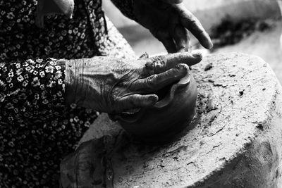 Close-up of person holding earthenware