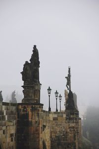 Statue of historic building against sky