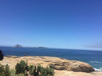 Scenic view of sea against clear blue sky