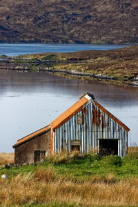 House on field by lake