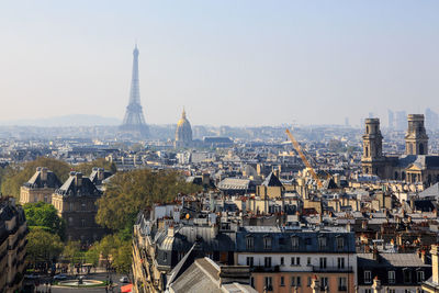 Aerial view of buildings in paris against clear sky