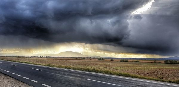 Storm clouds over road