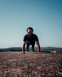 Full length portrait of young man against clear sky