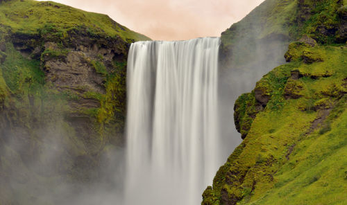 Scenic view of waterfall during sunset