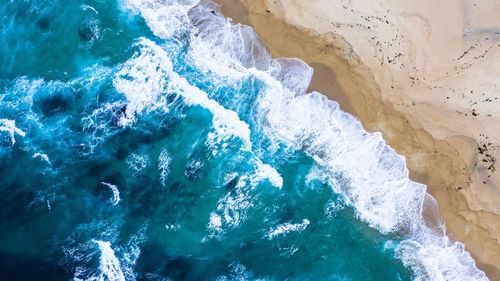 High angle view of sea waves splashing on shore