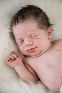 Cute baby lying on bed at home