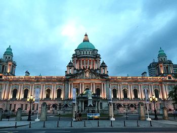 Low angle view of building against cloudy sky