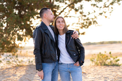 Couple wearing jacket standing outdoors