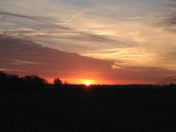 Scenic view of silhouette landscape against sky during sunset