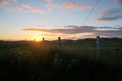 Scenic view of field against sky during sunset