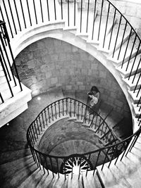 High angle view of woman walking on steps in building