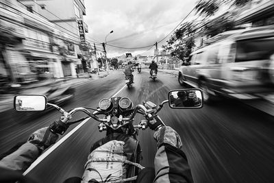 Cropped image of riding bicycle on road