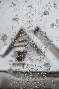 Close-up of wet airplane window