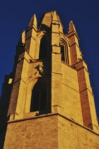 Low angle view of bell tower against sky