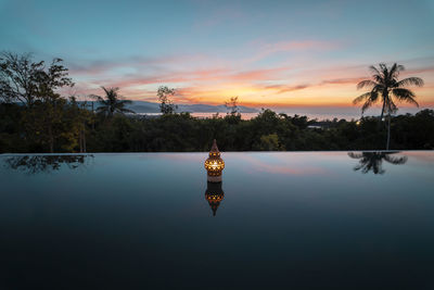 Scenic view of lake against sky during sunset