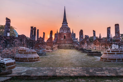 Panoramic view of temple and buildings against sky at sunset