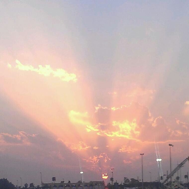 sunset, sky, cloud - sky, beauty in nature, scenics, orange color, nature, tranquility, tranquil scene, silhouette, low angle view, idyllic, street light, cloudy, cloud, built structure, outdoors, building exterior, no people, sun