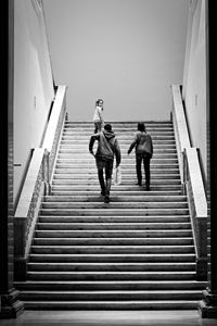 Low angle view of women walking on staircase