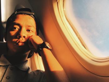 Close-up of young woman in airplane