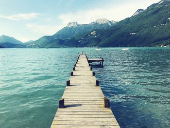 Pier over lake against sky