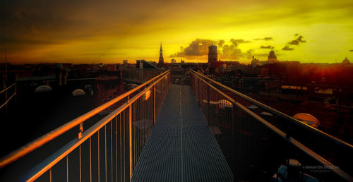 High angle view of bridge and buildings against sky during sunset